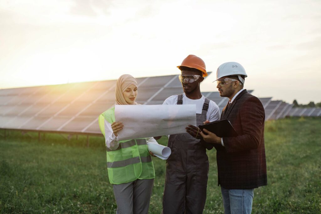 multi-ethnic-people-discussing-work-at-solar-stati-HFXPKUV.jpg